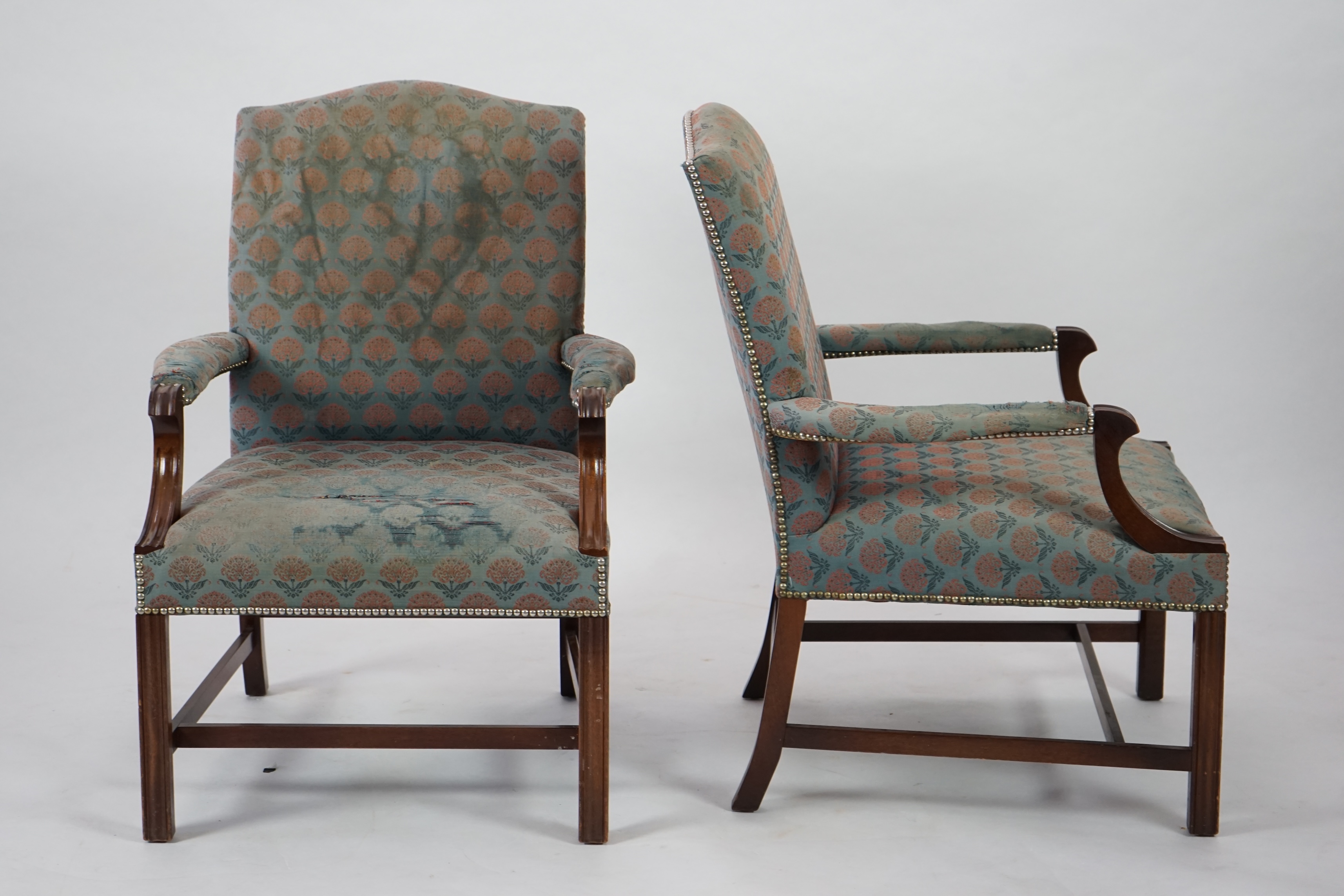 A pair of Thomas Glenister George III style mahogany Gainsborough armchairs